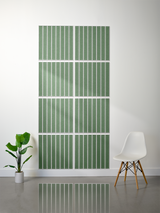 Eight green tiles with white vertical engraved lines arranged in a 4x2 grid on a wall.