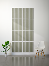 Eight sage green tiles with vertical engraved parallel lines arranged in a 2x4 grid on a wall.