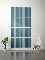 Eight teal tiles with parallel vertical engraved lines arranged in a 2x4 grid on a wall.