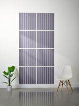 Eight purple and white tiles with parallel vertical engraved lines arranged in a grid pattern on a wall.
