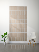 Eight beige tiles with white vertical engraved lines arranged in offset pattern on wall.
