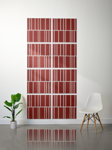 Eight red tiles with white engraved vertical stripe patterns arranged in offset grid formation on wall.