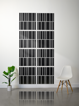 Eight black tiles with white vertical stripe engraving pattern arranged in offset 2x4 grid on wall.