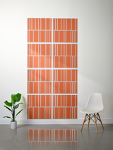 Eight terracotta tiles with white engraved vertical stripe pattern arranged in offset grid formation on wall.