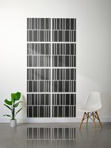 Eight dark gray tiles with white engraved vertical stripe pattern arranged in offset rows on wall.
