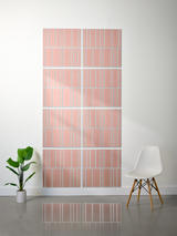 Eight terracotta tiles with white engraved vertical line patterns arranged in offset rows on a wall.