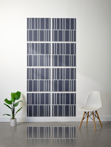 Eight dark blue tiles with white engraved vertical line pattern arranged in offset rows on wall.