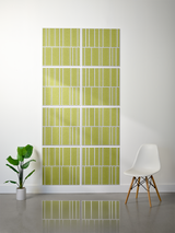 Eight olive green tiles with white engraved vertical line pattern in offset arrangement.