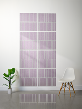 Eight lavender tiles with white engraved vertical line pattern arranged in offset rows on wall.