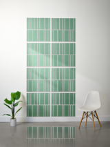 Eight green tiles with white vertical engraved lines in staggered pattern arrangement.