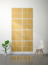 Eight gold tiles with white engraved vertical lines arranged in offset pattern on wall.