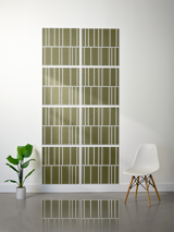 Eight olive green rectangular tiles with white engraved vertical line pattern arranged in offset layout on wall.