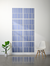 Eight blue tiles with white engraved vertical line pattern arranged in offset rows on wall.