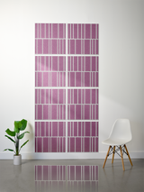 Eight mauve tiles with white vertical engraved lines in offset pattern arrangement on wall.