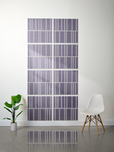 Eight purple tiles with white vertical stripe engraving arranged in offset pattern on wall.