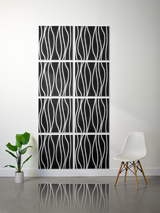 Eight black tiles with white wavy vertical line engravings arranged in a 2x4 grid on a wall.