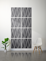 Eight dark gray tiles with white wavy vertical line engravings arranged in a 2x4 grid on a wall.
