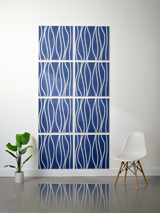 Eight blue tiles with white wavy engraved lines arranged in a 2x4 grid pattern on a wall.