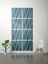 Eight teal tiles with white wavy line engraving arranged in a 2x4 grid on a wall.