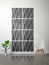 Eight black tiles with white wavy vertical line engravings arranged in a 2x4 grid on a wall.