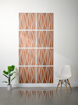 Eight terracotta tiles with white wavy engraved patterns arranged in a 2x4 grid on a wall.