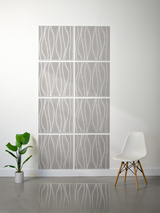 Gray tiles with white engraved wavy vertical lines arranged in a 2x4 grid on wall.