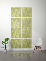 Eight green tiles with white wavy line engravings arranged in a 2x4 grid on a wall.