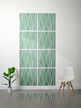 Eight green tiles with white wavy line engravings arranged in a 2x4 grid on a wall.