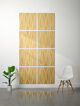 Eight golden tiles with white wavy engraved lines arranged in a 2x4 grid on a wall.