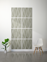 Eight sage green tiles with white wavy vertical line engravings arranged in a 2x4 grid on a wall.
