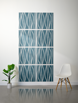 Eight teal tiles with white wavy engraved lines arranged in a 2x4 grid on a wall.