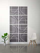 Set of eight gray square tiles with white engraved lines and geometric patterns arranged in a 2x4 grid on wall.