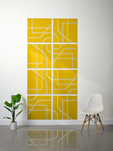 Eight yellow square tiles with white engraved lines in geometric subway-style pattern arranged in grid formation on wall.