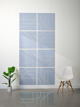 Eight blue subway tiles with engraved geometric line patterns arranged in a 2x4 grid on white wall.