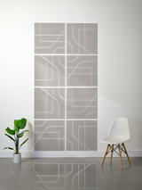 Eight gray tiles with white engraved geometric lines and curved patterns arranged in a 2x4 grid on a wall.