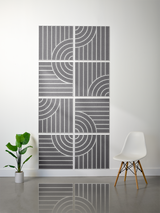 Gray tiles with engraved vertical lines and curved arc patterns forming a geometric grid design.