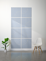 Eight blue-gray square tiles with engraved concentric arc and vertical line patterns arranged in a grid wall display.