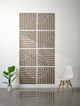 Eight tan tiles with engraved vertical lines and curved arc patterns creating a geometric tangent design.