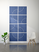 Eight blue tiles with white engraved geometric lines and curved arc patterns arranged in a 2x4 grid on a wall.