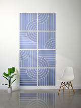 Blue tiles with engraved curved and linear patterns arranged in a 4x2 grid on a wall.