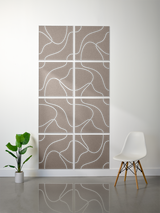 Eight taupe tiles with white topographic contour line engravings arranged in a 2x4 grid on a wall.