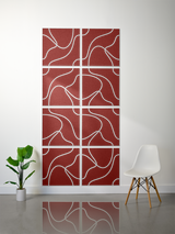 Eight deep red square tiles with white topographic contour line engravings arranged in a 2x4 grid on a wall.