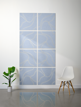 Eight blue square tiles with engraved curved topographic lines in light gold arranged in a grid pattern.