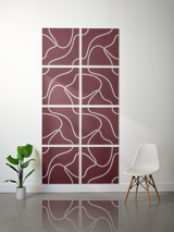Eight burgundy square tiles with white engraved topographic contour lines arranged in a 2x4 grid on a wall.