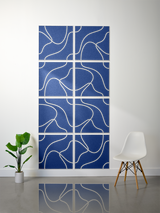 Eight blue tiles with cream-colored topographic line engravings arranged in a 2x4 grid.