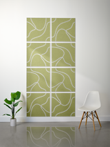 Eight olive-green tiles with white topographic line engravings arranged in a 2x4 grid pattern on a wall.