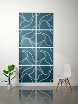 Eight teal tiles with white engraved topographic line patterns arranged in a 2x4 grid on a wall.