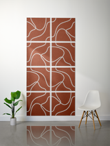 Eight rust-brown tiles with white engraved topographic line patterns arranged in a 2x4 grid on a wall.