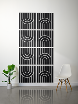 Eight black tiles with white engraved geometric arch and line patterns arranged in a 2x4 grid on a wall.