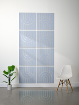 Eight light blue tiles with engraved geometric arch and vertical line patterns arranged in a 2x4 grid on a wall.